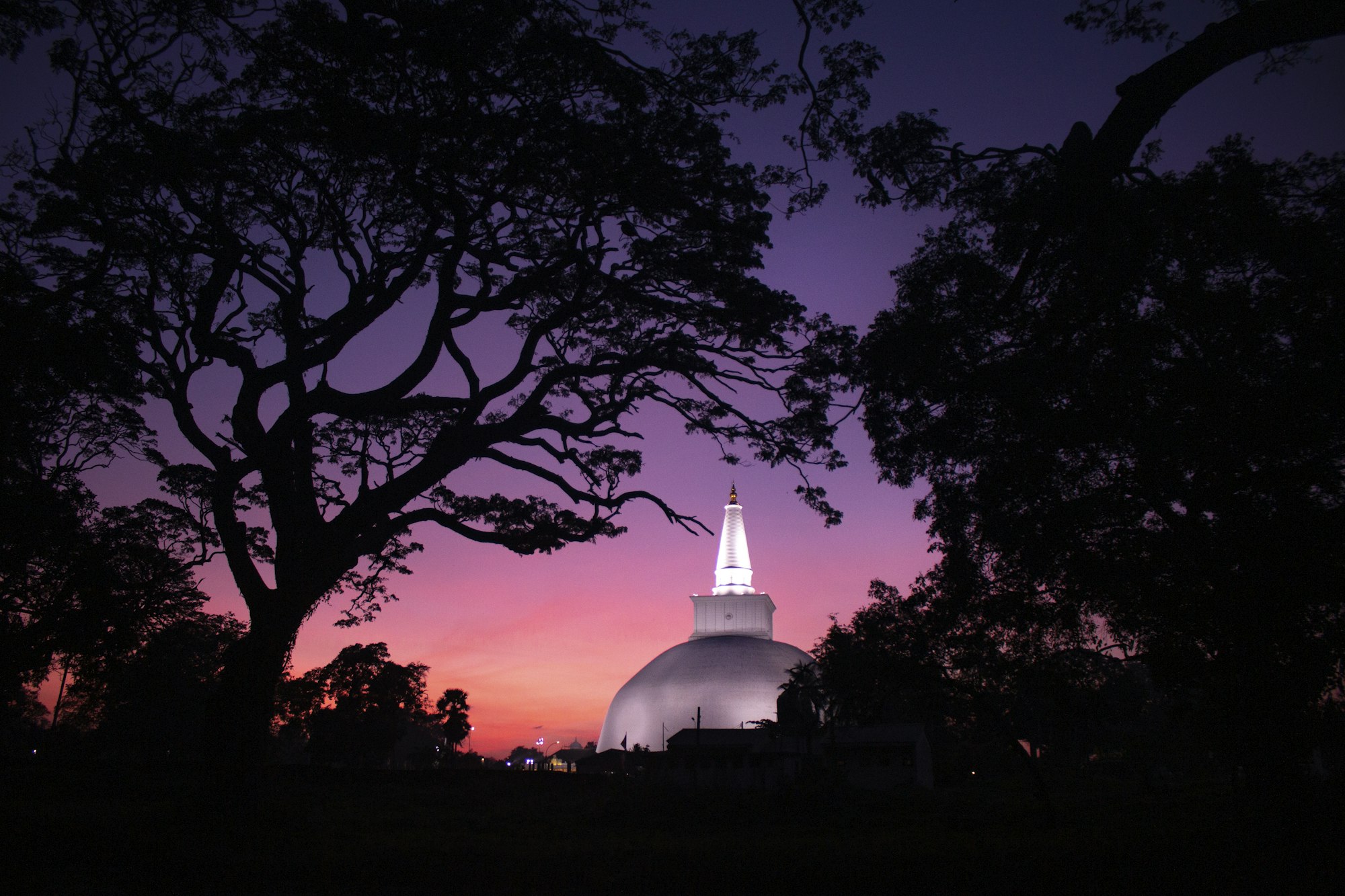A vast white stupa rising above the ruins of an ancient Sri Lankan capital.